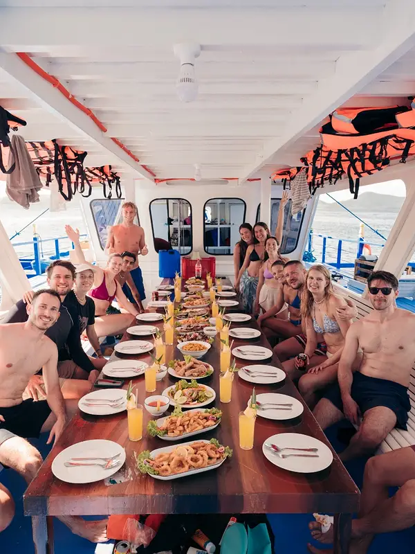 Communal lunch on the boat deck with grilled seafood and fresh juice