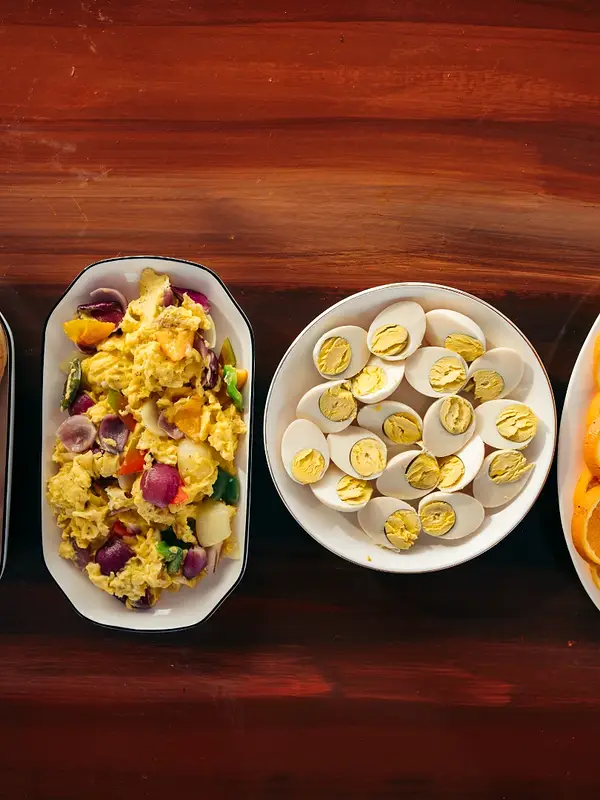Filipino breakfast spread with rice, eggs, and fruit