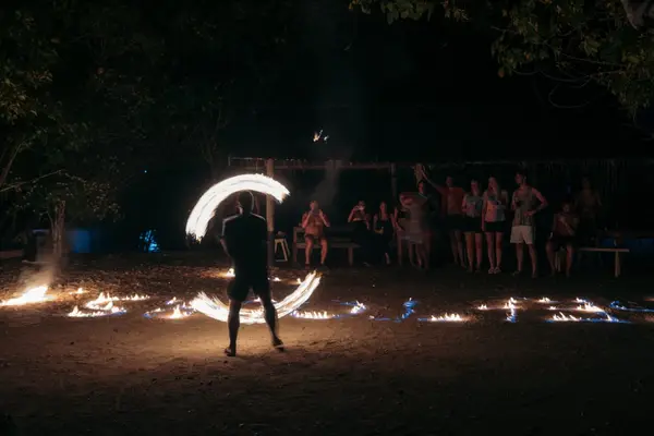 Local fire dancer at the Seatours beach campsite at night