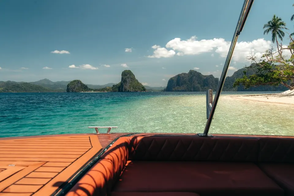 Semi-private El Nido speedboat tour cruising through Bacuit Bay limestone islands
